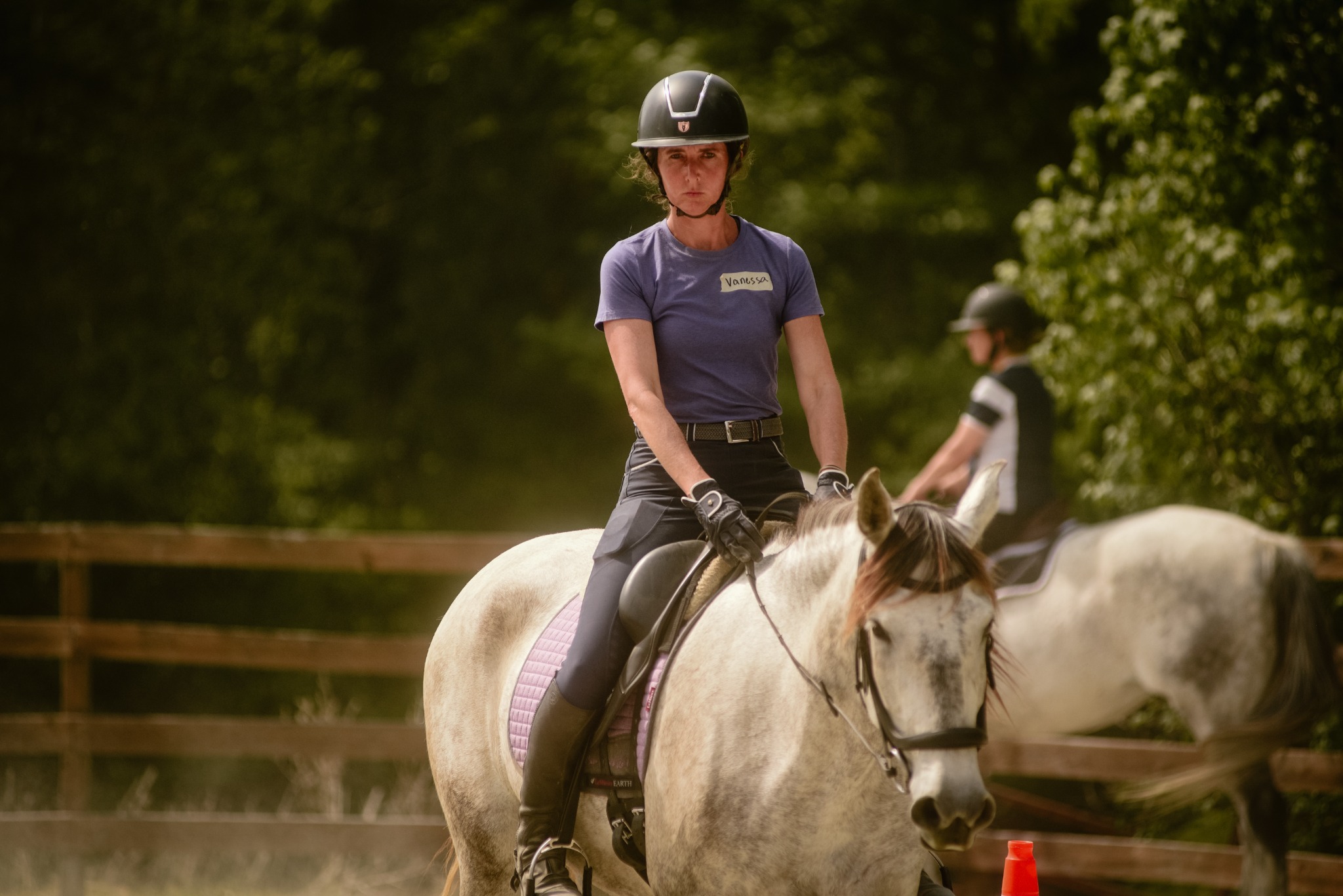 Rider communicating with her horse in the arena